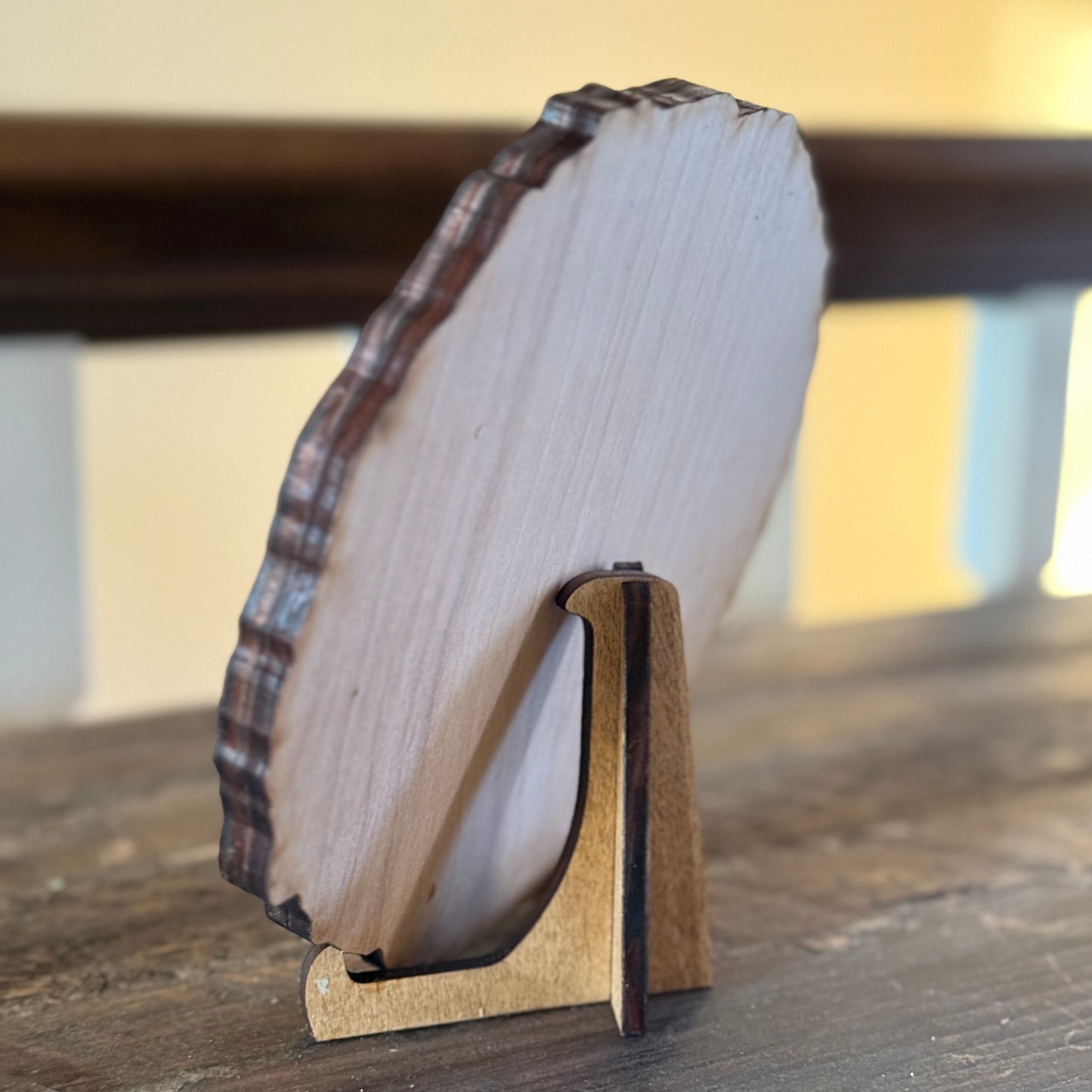 Back view of engraved wooden plaque showing natural wood grain and display stand