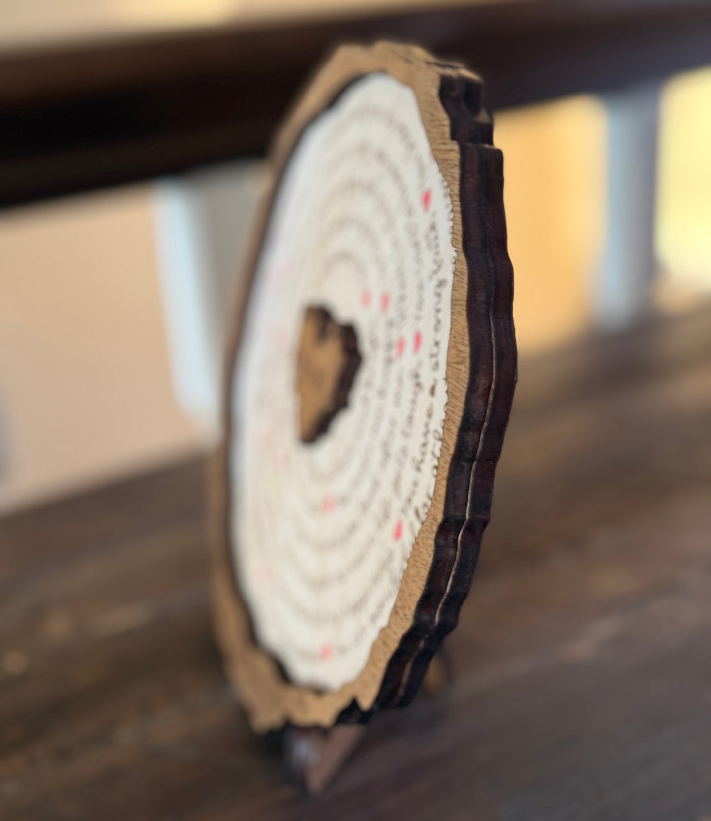 Side view of engraved wooden plaque showing natural bark edge and wood thickness