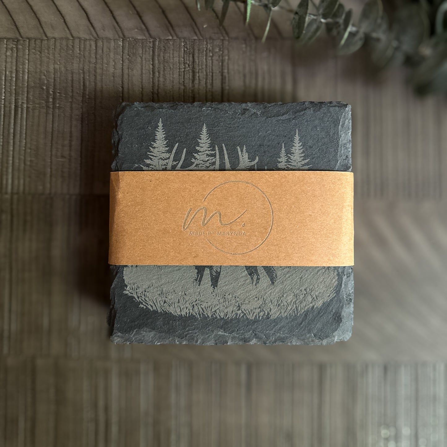 Stack of engraved wildlife slate coasters wrapped in kraft paper band with Made by Marynda logo – ready to gift.