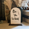 Decorative sign with 'Be the Wheat' text in a home setting