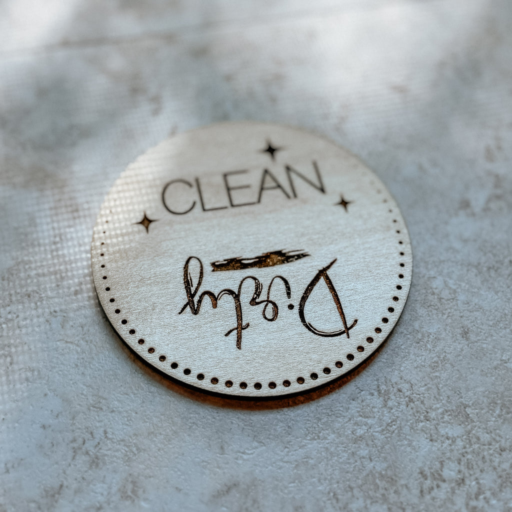Round 'CLEAN' label with signature on a textured surface
