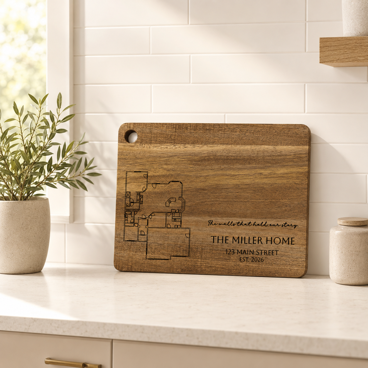 Personalized acacia cutting board engraved with a custom home floor plan, family name, address and established year