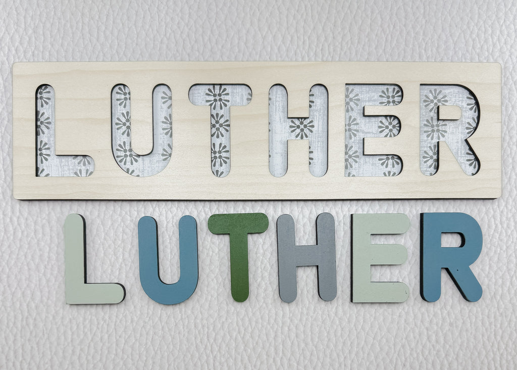 Wooden name puzzle with colorful raised letters and floral background – personalized baby gift
