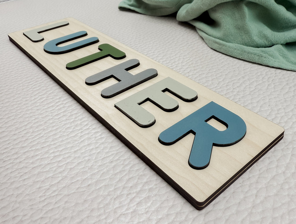 Angled view of personalized wooden name puzzle with raised letters – handcrafted baby gift