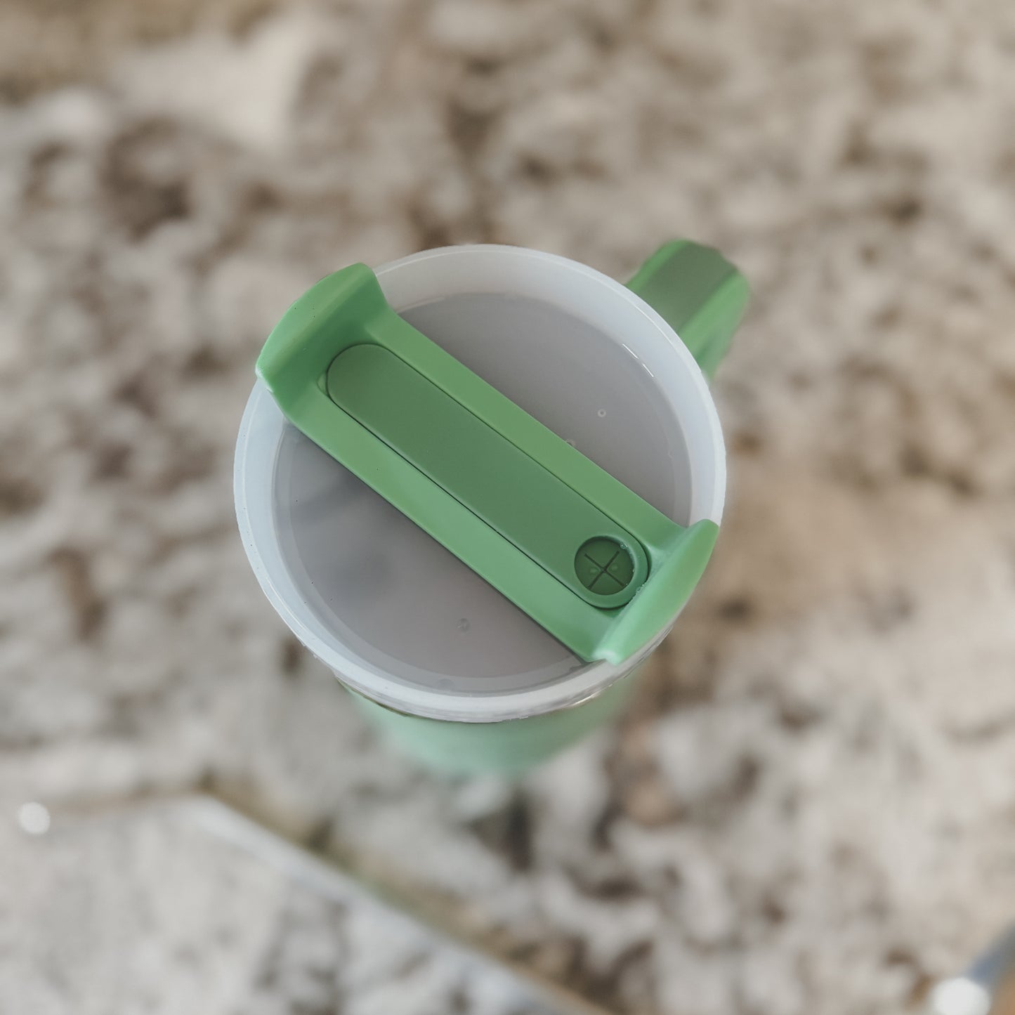 Top view of mint green 40oz tumbler with screw-on lid closed, shown on a marble surface

