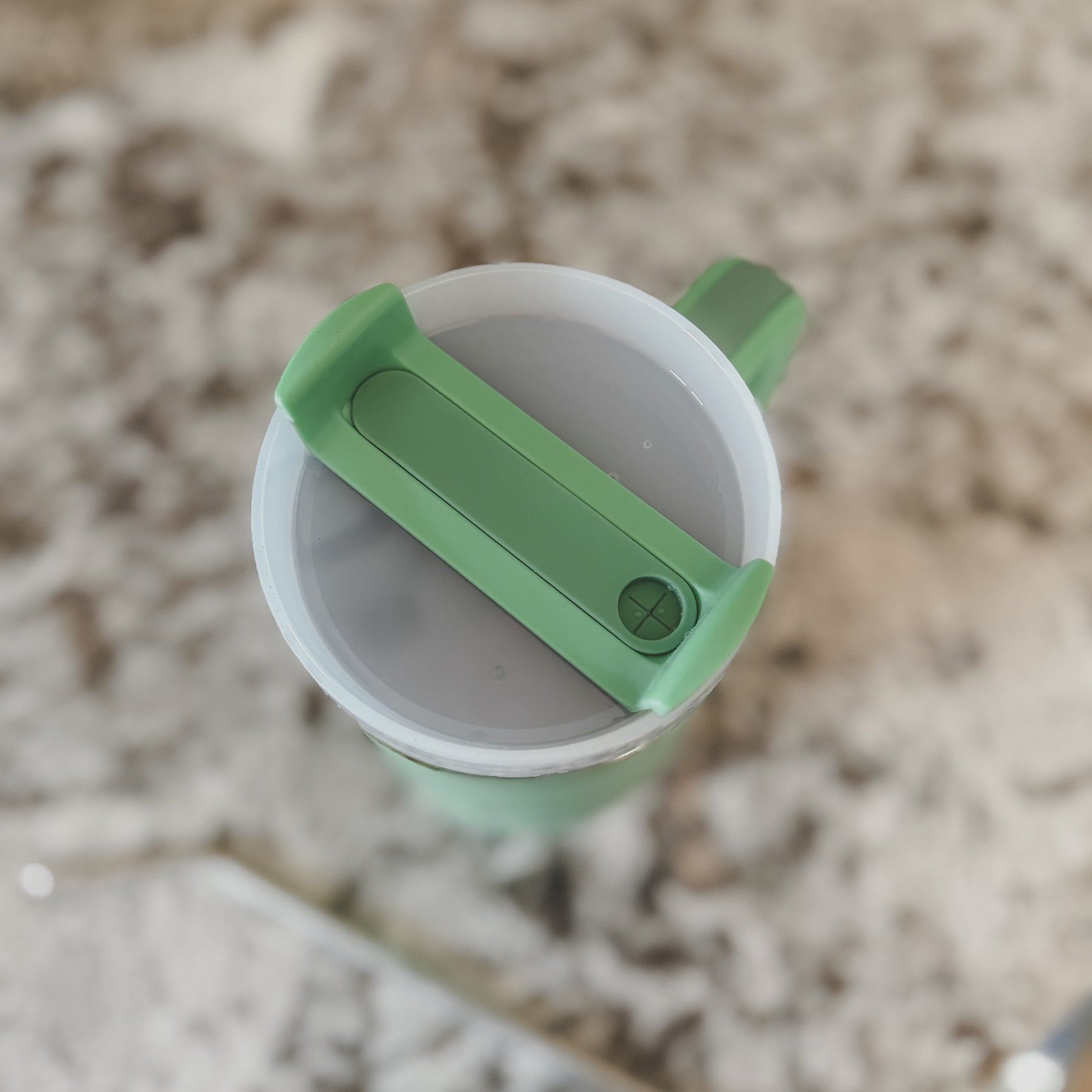 Top view of mint green 40oz tumbler with screw-on lid closed, shown on a marble surface

