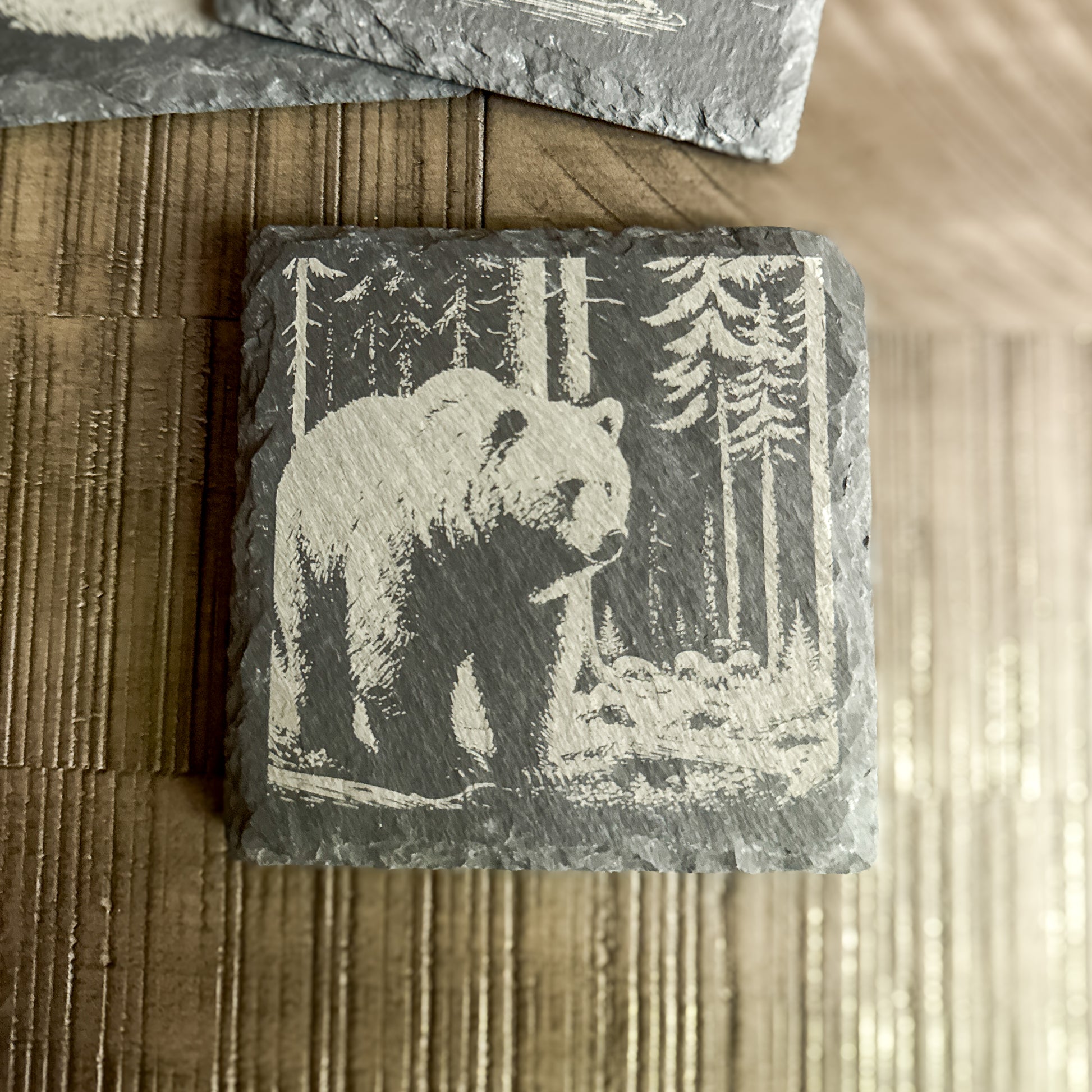 Slate drink coaster featuring a laser-engraved grizzly bear in the woods – woodland gift idea.